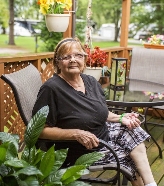 A woman sitting on her outdoor patio